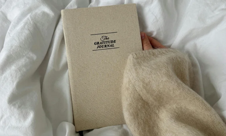 The Gratitude Journal held in wool sweater sleeve